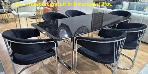 Set dining de top NORA ELITE compus din masă cu blat MDF negru lăcuit și șase scaune ergonomice cu picioare cromate, expus în showroom-ul Ferremo Otopeni.